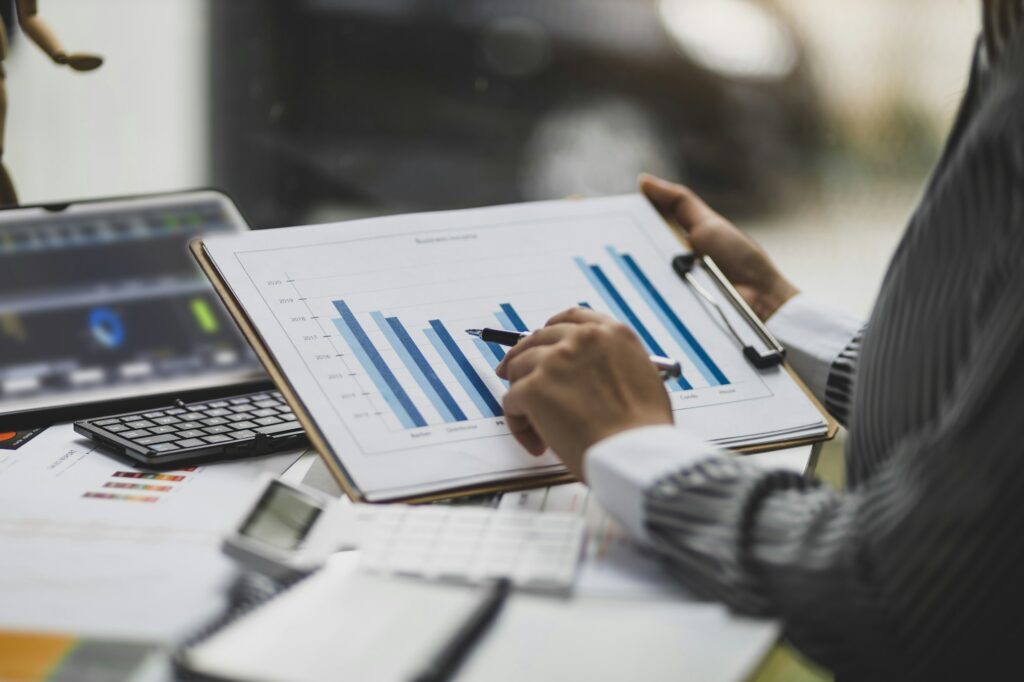 Financial consultant businesswoman analyzing charts in financial report, Analyze investment planning